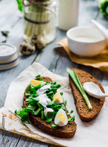 rye bread with wild garlic, sour cream and quail eggs