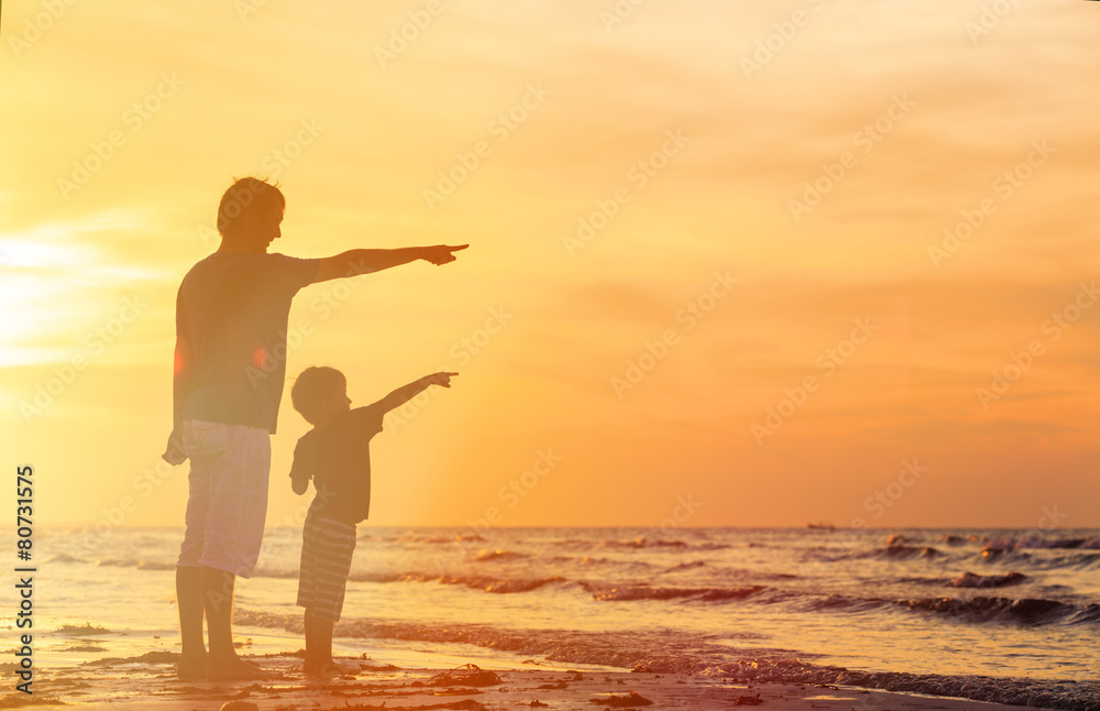 father and son at sunset beach