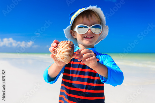 little boy found seashells on summer  beach