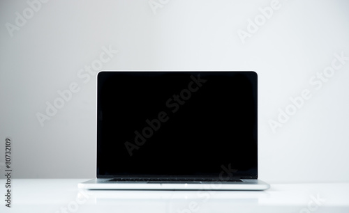 Laptop with blank screen on the table