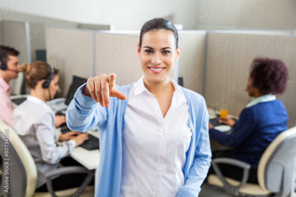 Obraz premium Female Call Center Employee Pointing In Office
