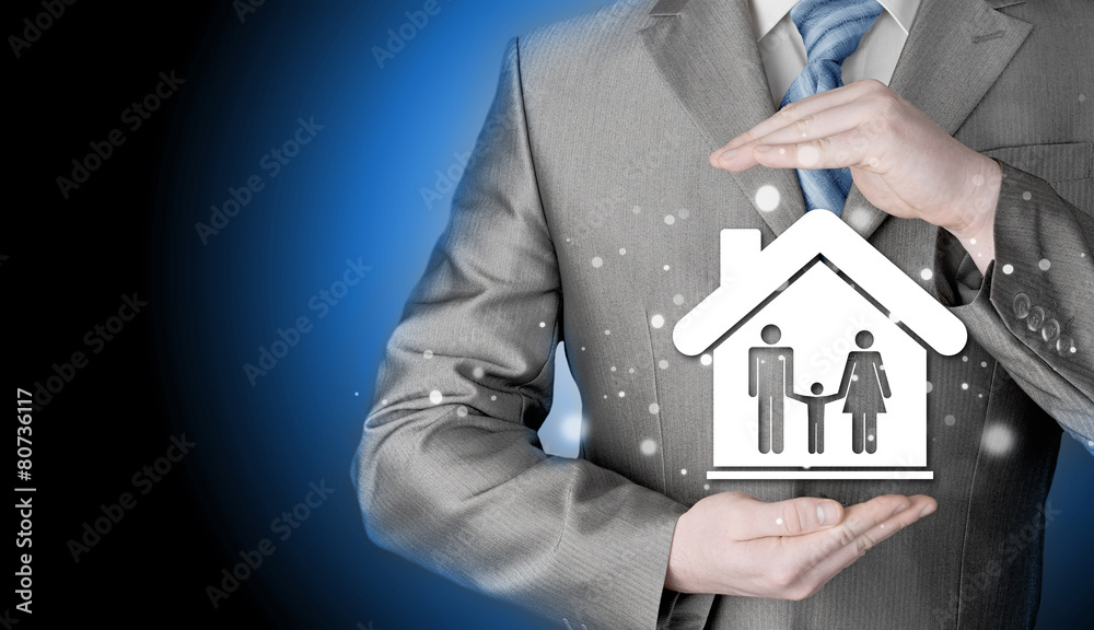 businessman protecting family in home with hands businessman protecting family in home with hands