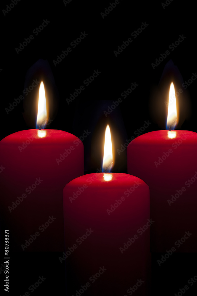 red candles lighting in the darkness red candles lighting in the darkness
