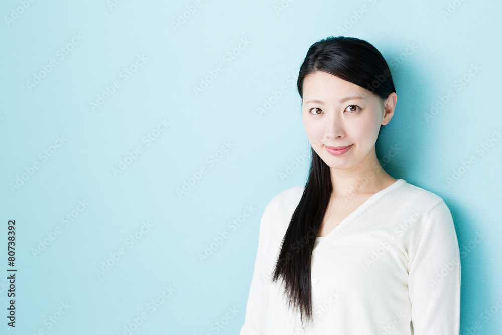 attractive asian woman on blue background attractive asian woman on blue background