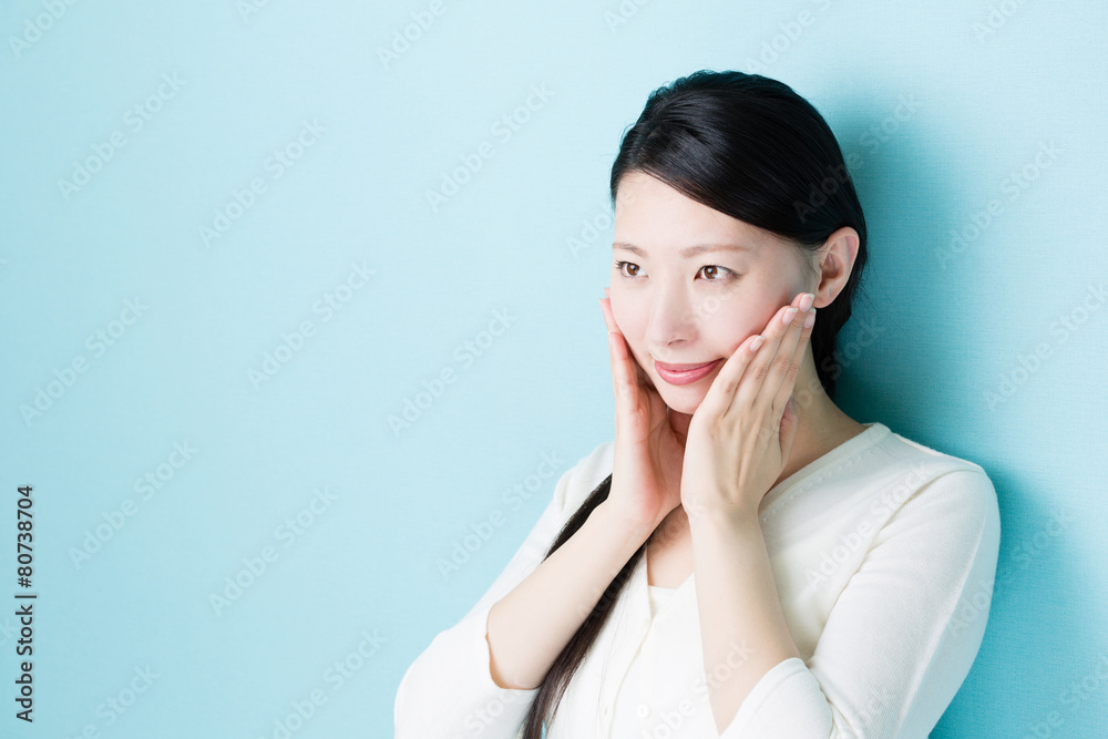 attractive asian woman on blue background attractive asian woman on blue background