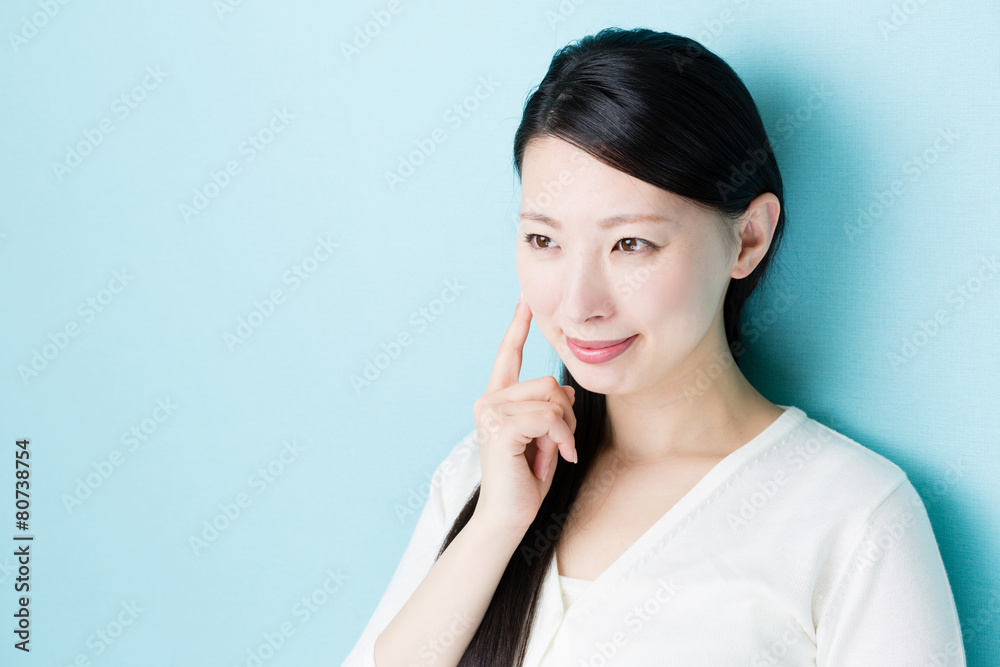 attractive asian woman on blue background attractive asian woman on blue background