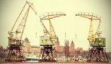 Retro stylized picture of port cranes in Szczecin City, Poland.