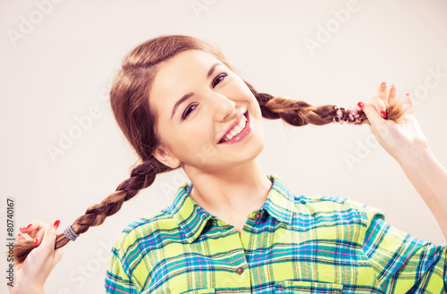 playful teen girl with pigtails photo