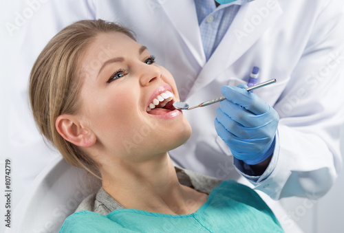 Dental care. Young woman treating her teeth in dentist office.