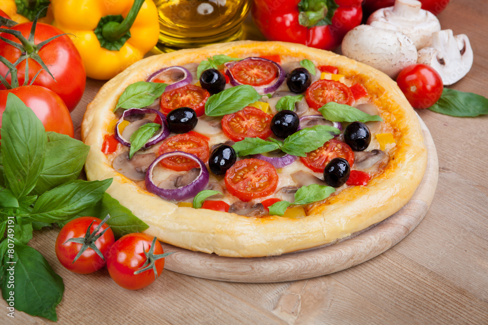 Tasty pizza and fresh ingredients on the table Tasty pizza and fresh ingredients on the table