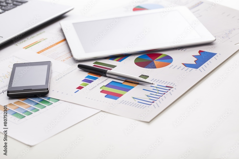 Market. Financial charts on the table with tablet phone and pen Market. Financial charts on the table with tablet phone and pen