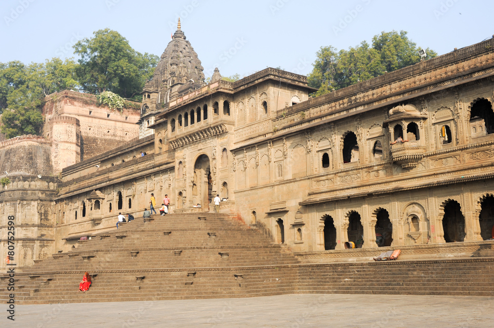 People walking in front of Maheshwar palace on India