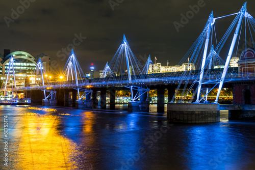The Jubilee Bridge in London at night. photo