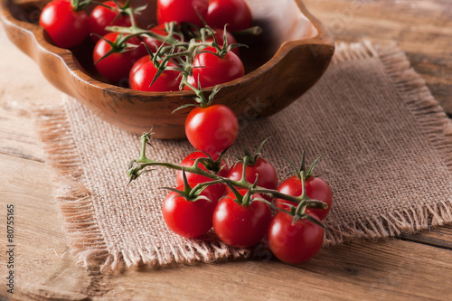 Close-up of fresh, ripe cherry tomatoes on wood