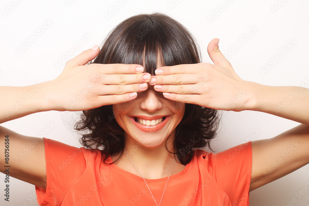 Young woman covering her eyes with her hands. Young woman covering her eyes with her hands.