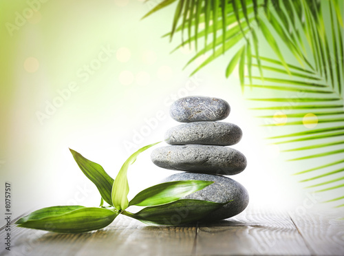 Stack of spa stones on light green background