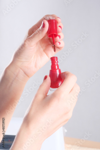 Red nail polish.