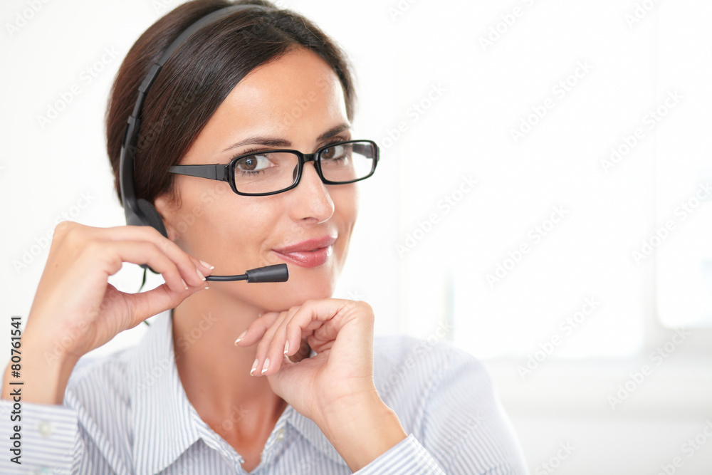 Confident adult employee speaking on headphones Confident adult employee speaking on headphones