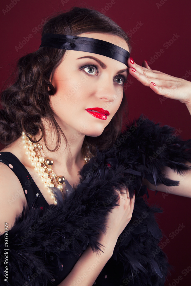 beautiful retro woman posing against wine red background beautiful retro woman posing against wine red background