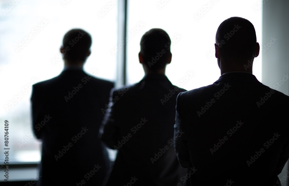 silhouette of three businessmen in the office