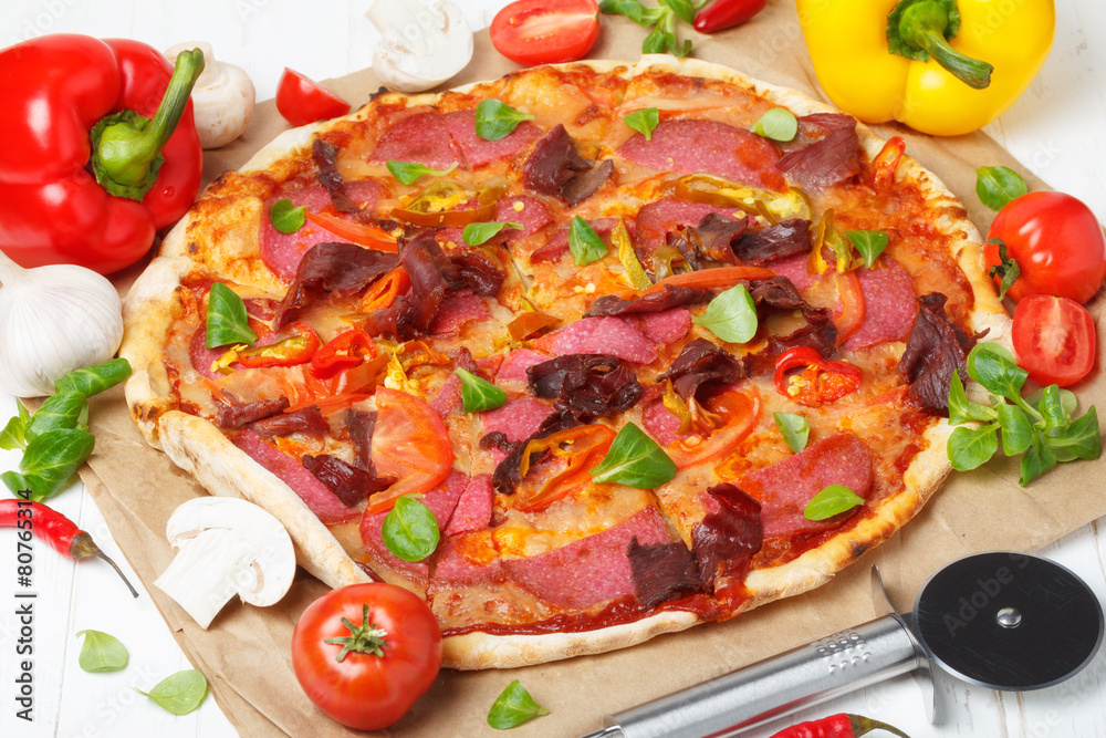 Traditional home made pizza with ham and salami Traditional home made pizza with ham and salami