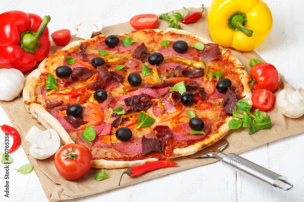 Classic traditional home made pizza with ham and salami Classic traditional home made pizza with ham and salami