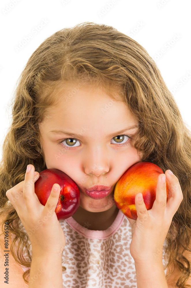 Cute little preschooler girl holding two peaches Cute little preschooler girl holding two peaches
