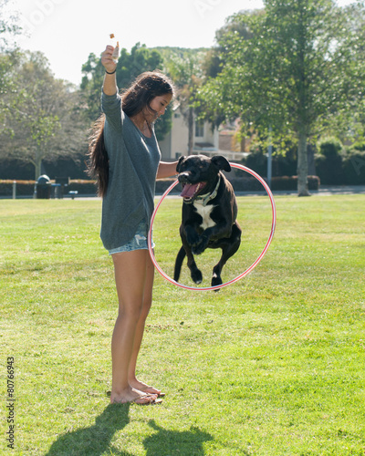 Wallpaper Mural Girl teaching her Labrador puppy to jump through hoop Torontodigital.ca