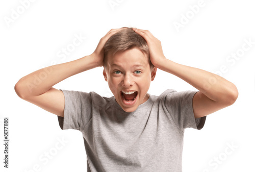 Amazed teenager holding his head