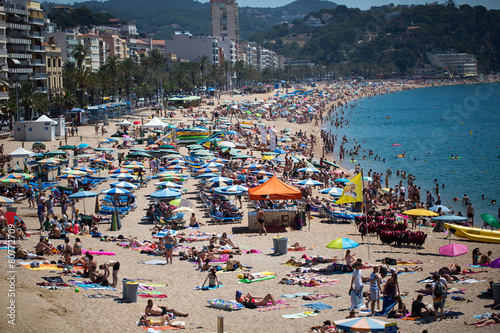 People and sun umbrellas on the beach