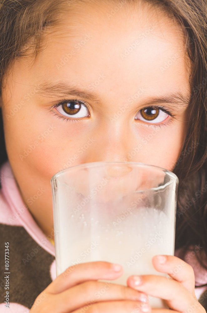Cute little preschooler girl drinking a glass of milk Cute little preschooler girl drinking a glass of milk