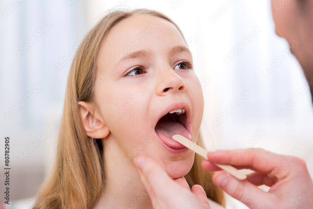 Young little girl being examinated by a doctor Young little girl being examinated by a doctor