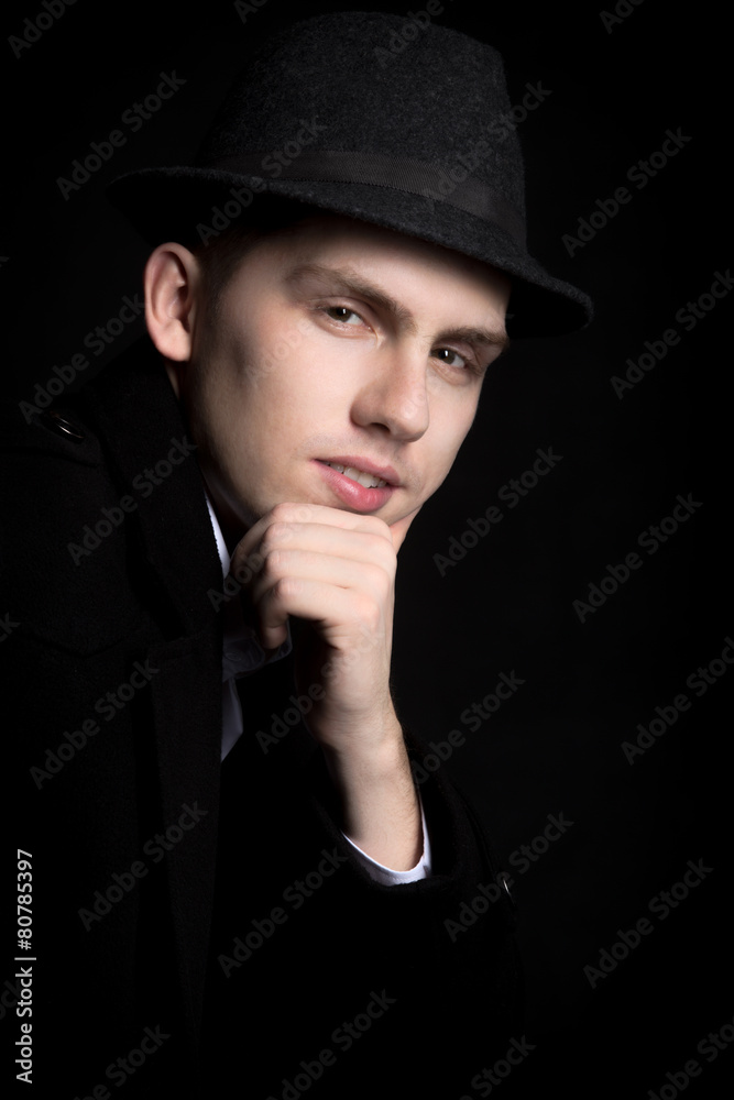 Portrait of smiling young man in hat and coat Portrait of smiling young man in hat and coat