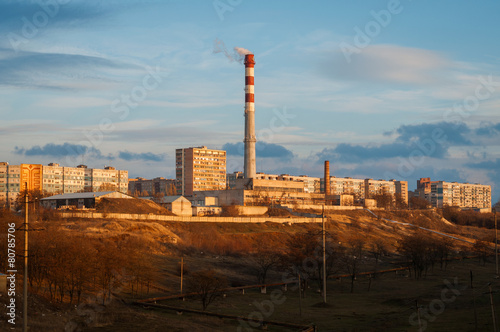 Smokestacks polluting the air over the city