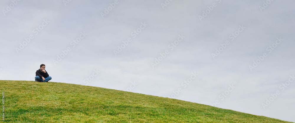 Young boy on a dune-Horizon over green grass Young boy on a dune-Horizon over green grass