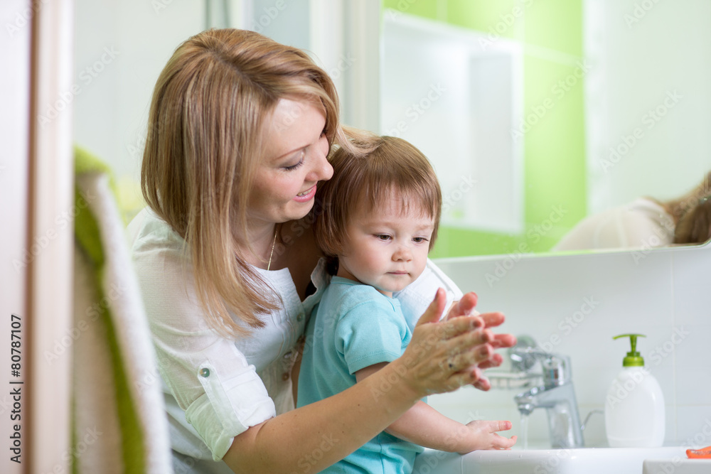 child boy washing hands with soap in bathroom child boy washing hands with soap in bathroom