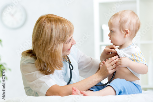pediatrician examining hear...