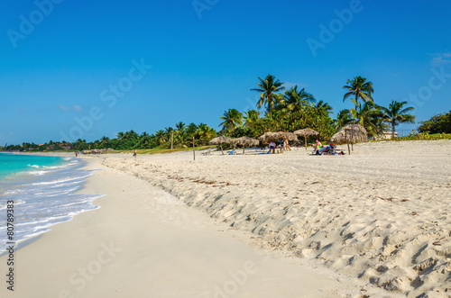 Amazing sandy beach with palm trees, azure Caribbean Sea
