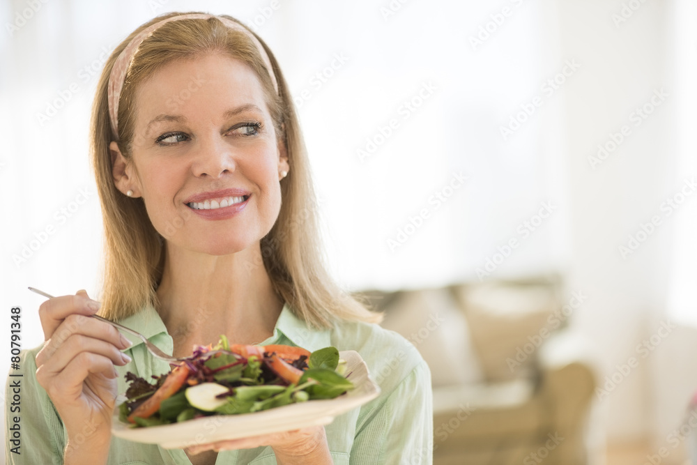 Smiling Mature Woman Having Salad At Home Smiling Mature Woman Having Salad At Home