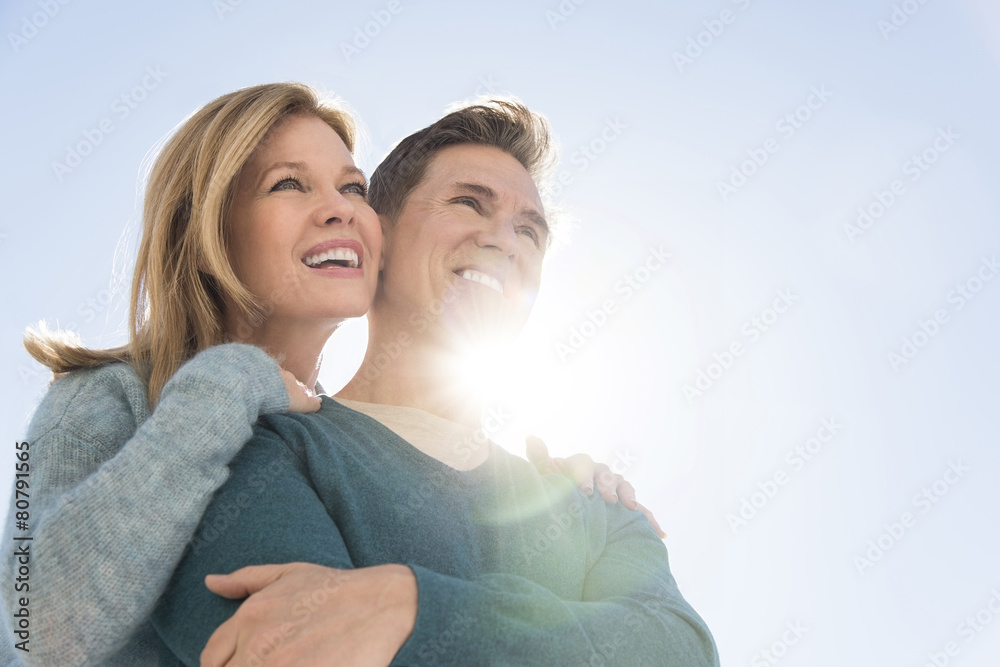 Low Angle View Of Couple Against Clear Sky Low Angle View Of Couple Against Clear Sky
