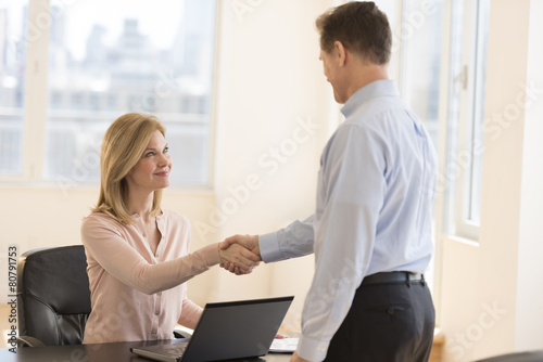 Businesswoman Greeting Candidate During Interview