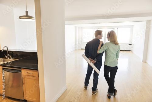Rear View Of Couple Standing In New House