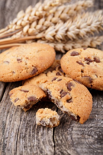 Tasty cookies with wheat on a wooden table.