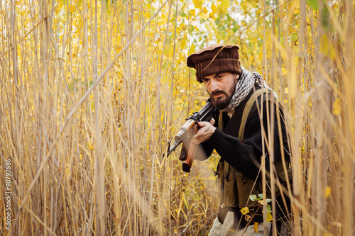 Portrait of serious middle eastern man with rifle photo