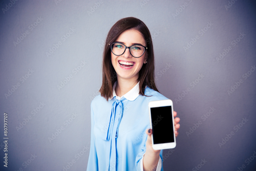 Laughing businesswoman showing blank smartphone screen Laughing businesswoman showing blank smartphone screen
