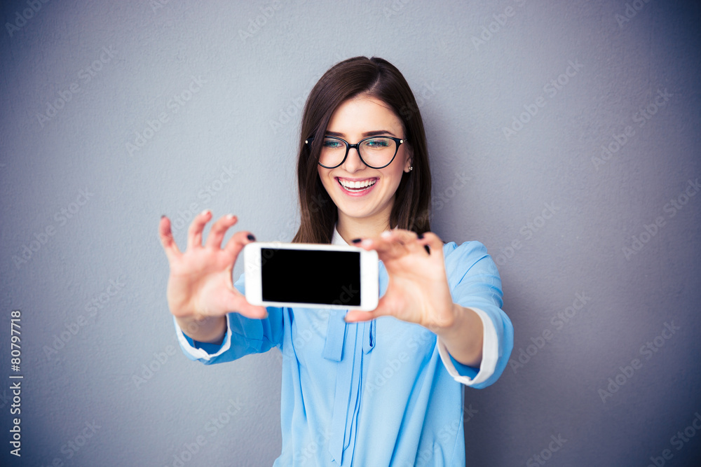 Laughing businesswoman making selfie photo