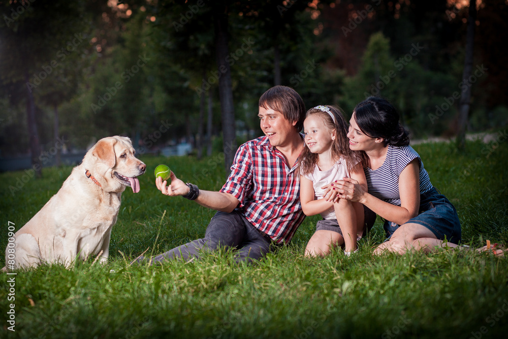 Fototapeta premium family pllaying with dog