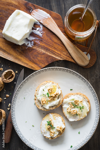 Картината върху платно Bruschette with Stracchino Cheese, Honey, Walnuts and Thyme