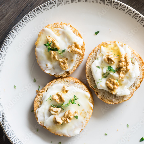 Tableau sur toile Bruschette with Stracchino Cheese, Honey, Walnuts and Thyme