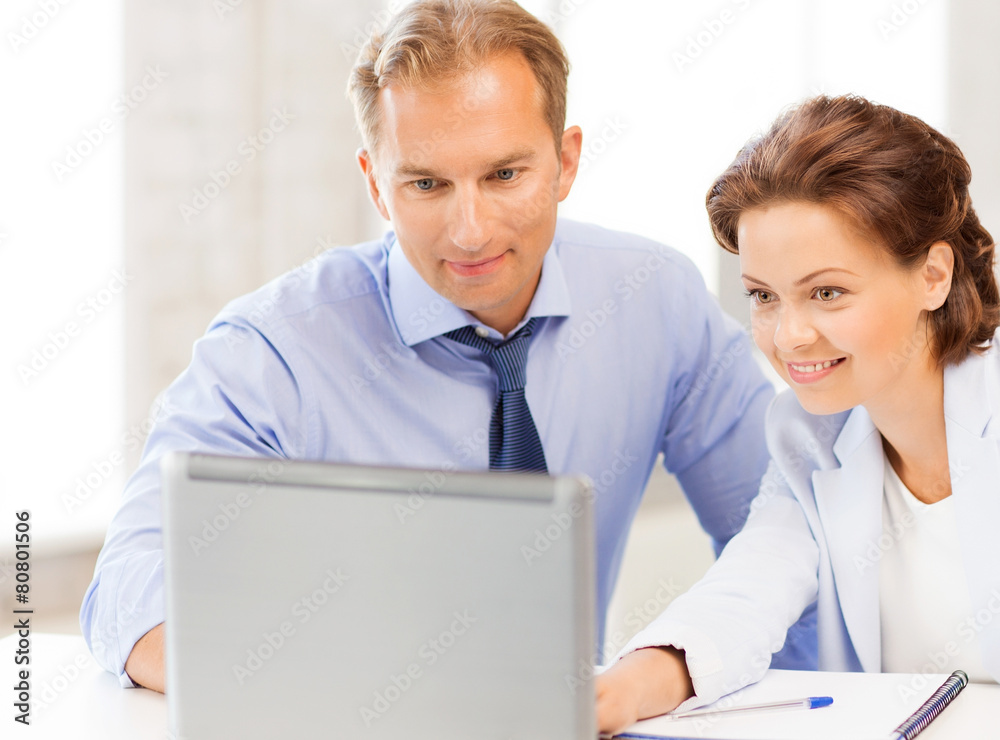 man and woman working with laptop in office man and woman working with laptop in office
